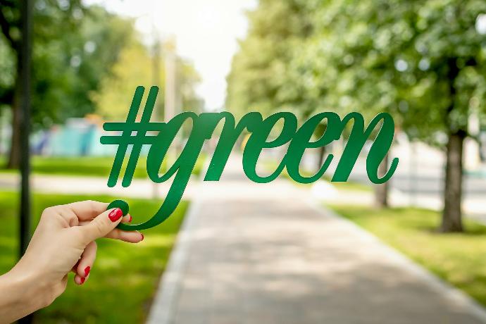 Green person holding green signage